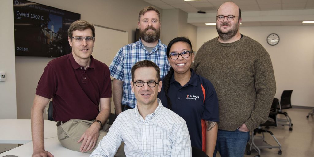 CBTF founders, Craig Zilles, far left, Matthew West, foreground center, and Patrick Bailey, back row second from left, join administrative team members, Carleen Sacris and David Mussulman, far right.